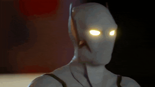a close up of a superhero with yellow eyes
