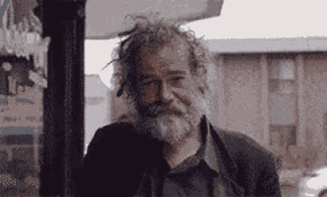 a pixelated image of a man with a beard and glasses looking at the camera