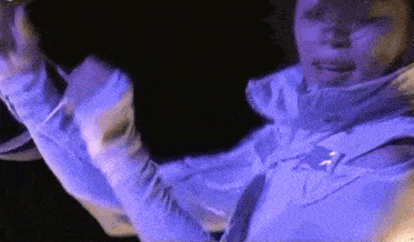 a person wearing a white jacket with holes in the sleeves