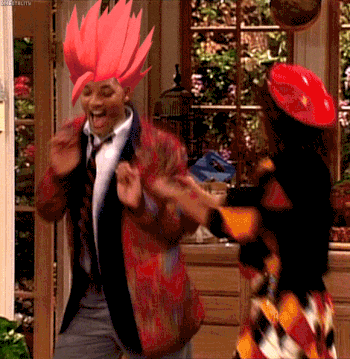 a man with red hair is dancing with a woman wearing a red hat