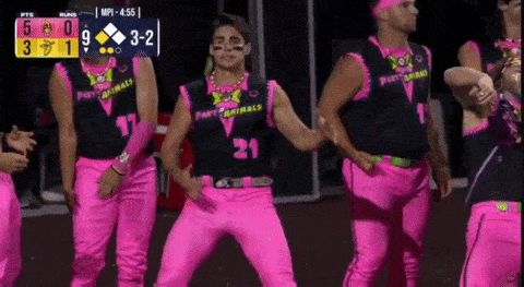 a group of people wearing pink pants and black shirts with the number 21 on them