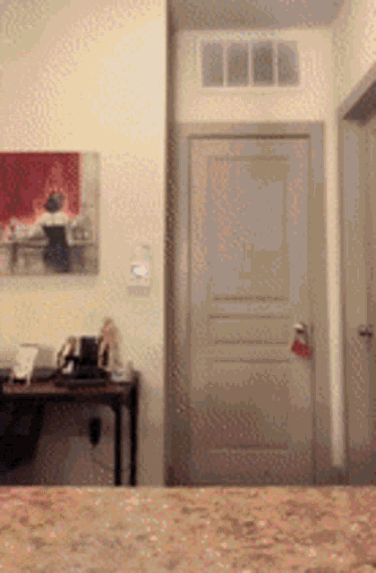 a bedroom with a painting on the wall above a door