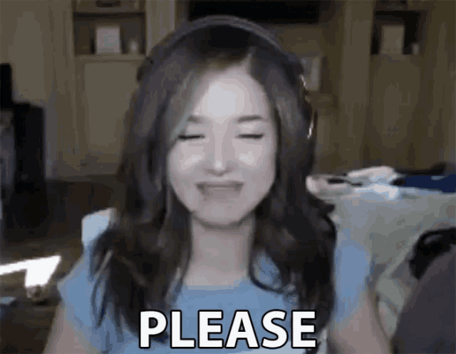 a woman is wearing headphones and making a please sign .