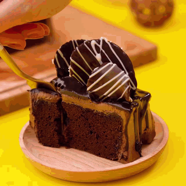 a piece of chocolate cake on a plate with a spoon