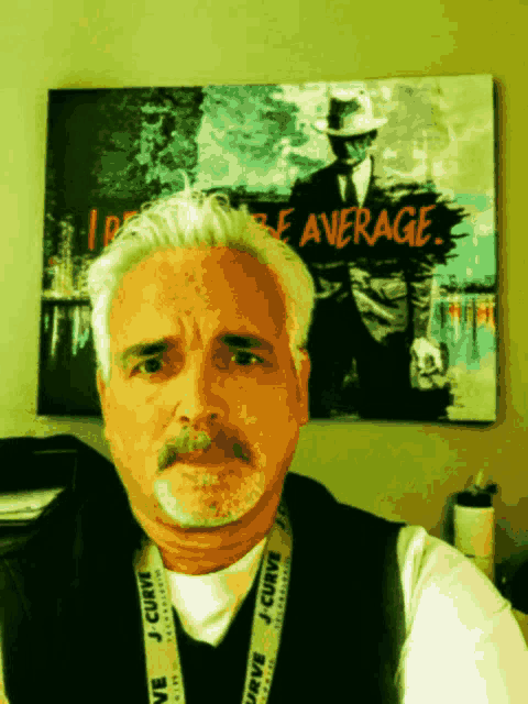 a man with a lanyard that says j curve