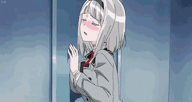 a girl with short white hair is standing in a doorway with her eyes closed