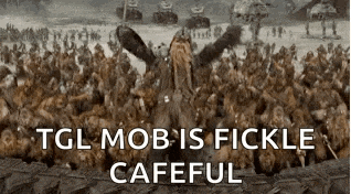 a moose is standing in front of a crowd of people with the words `` tgl mob is fickle cafeful '' .