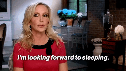 a woman in a red dress is saying " i 'm looking forward to sleeping "