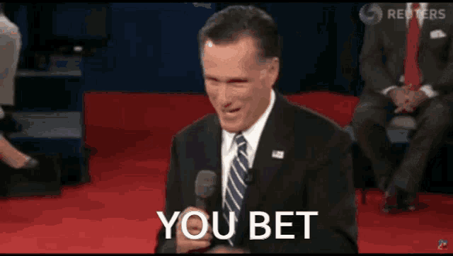 a man in a suit and tie smiles and says you bet