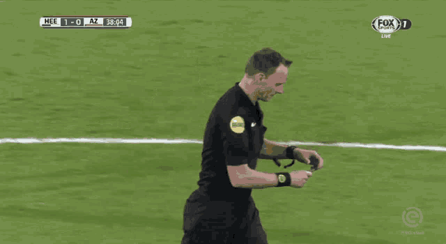 a referee holds up a yellow card during a soccer match