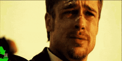 a man in a suit and tie is crying with a bandage on his forehead .