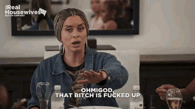 a woman sitting at a table says ohmigod that bitch is fucked up on the screen