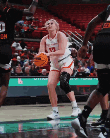 a female basketball player wearing a number 13 jersey