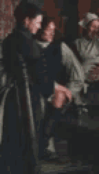 a blurry picture of a group of people standing next to each other in a room .