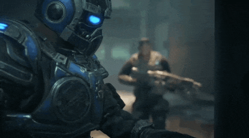 a man in a blue armored suit is holding a gun