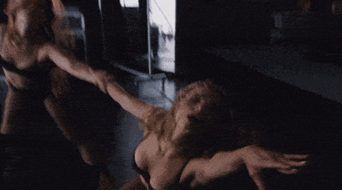 a blurry photo of a woman in a black leotard