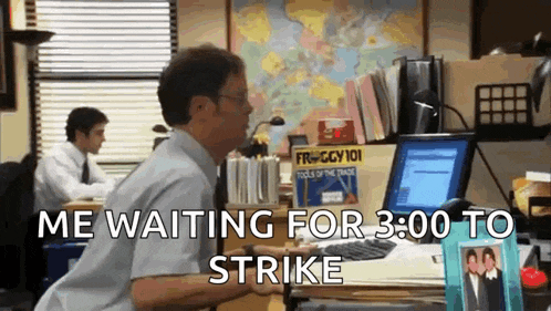 a man sitting at a desk with the words " me waiting for 3:00 to strike " above him
