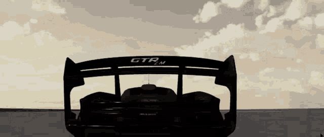 a black car with a spoiler that says gtr on it