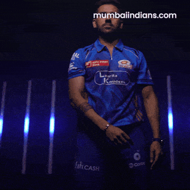 a man wearing a blue shirt that says mumbai indians