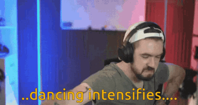 a man wearing headphones and a baseball cap says dancing intensifies