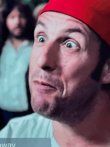 a man wearing a red hat is making a funny face with the word away in the corner