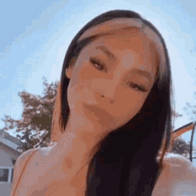 a close up of a woman taking a selfie with her hair in a headband .