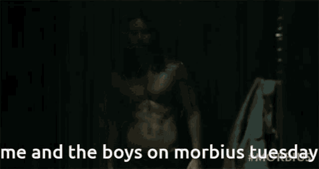 a shirtless man stands in a dark room with the words me and the boys on morbid tuesday