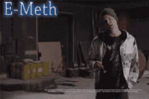 a man standing in front of a sign that says e-meth you know it 's good
