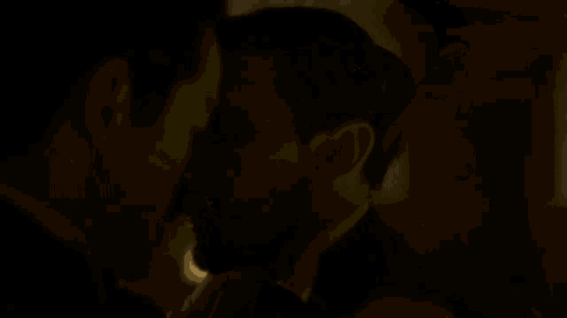 a man kissing another man with the words cuando se vive en familia hay que hacer concesiones behind him