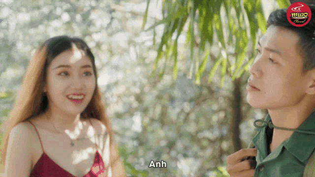 a man and a woman are standing next to each other and the man says anh