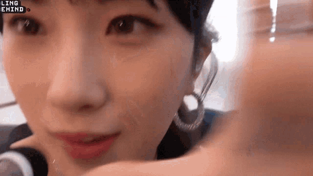 a close up of a woman 's face with the word ling behind her .