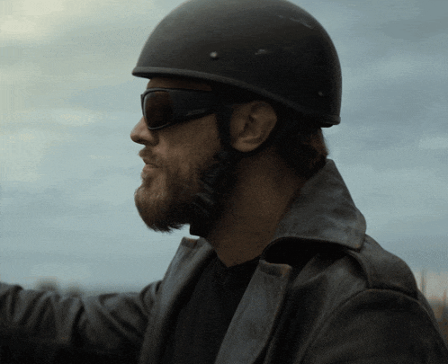 a man wearing a helmet and sunglasses has the word simpson on his sunglasses
