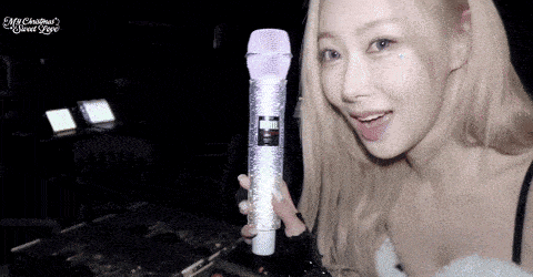 a woman holding a microphone with the words my christmas sweet love written on the bottom