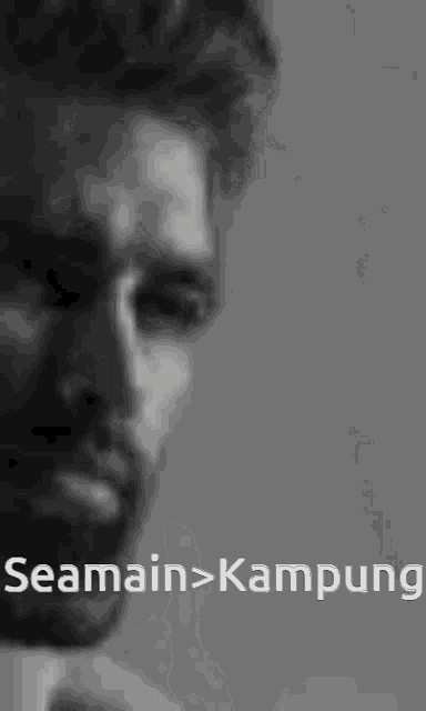 a black and white photo of a man with the words semain > kampung on the bottom right