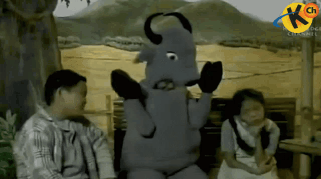 a cartoon character with horns and a k channel logo on the bottom right