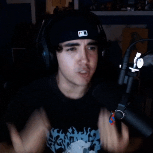 a man wearing headphones and a hat with the letter a on it