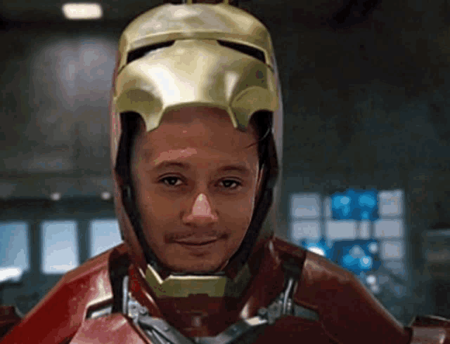 a man wearing a helmet that looks like iron man is smiling