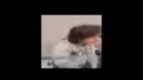 a blurry picture of a person with smoke coming out of their mouth .