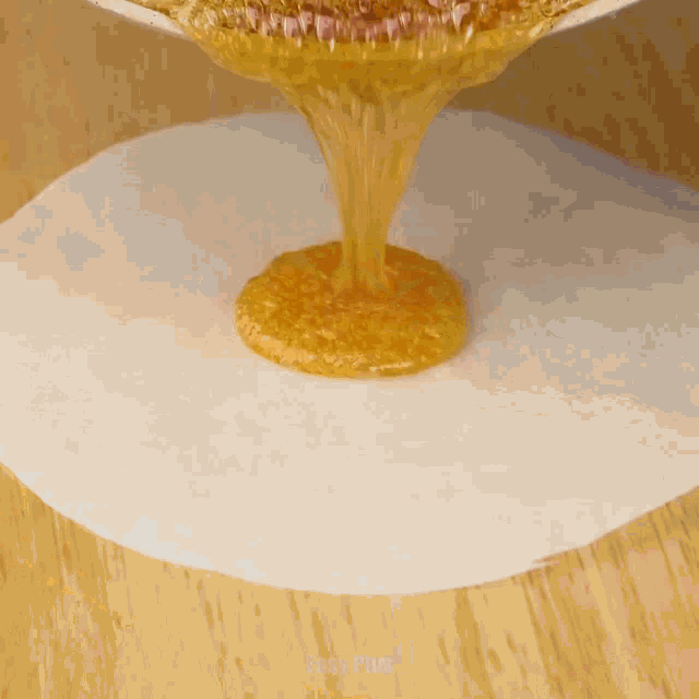 honey is poured onto a piece of wax paper