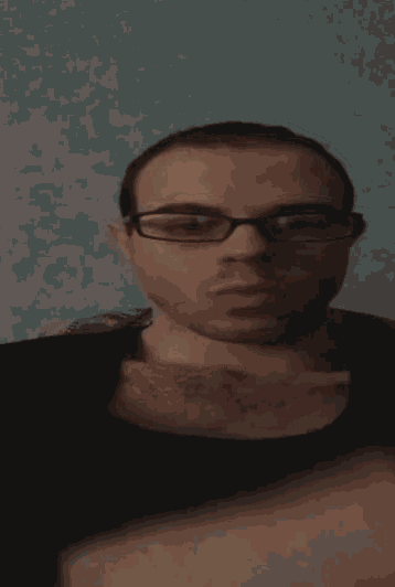 a man with glasses is making a funny face with his mouth open