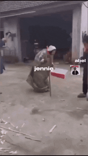 a woman in a long dress is holding a box with jennie and abel written on the bottom