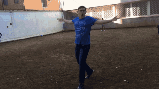 a man in a blue shirt with the number 72 on it