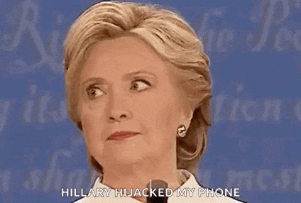 hillary clinton is talking into a microphone and saying `` hillary hijacked my phone ''