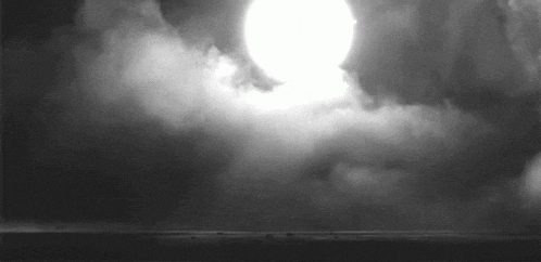 a black and white photo of the sun shining through the clouds