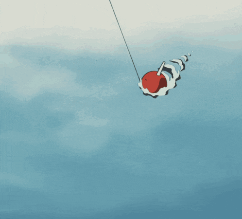 a red buoy is floating in the water with a fishing rod attached to it