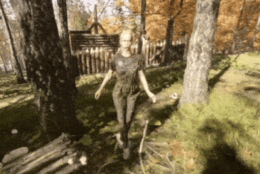 a woman in a dirty shirt is walking in the woods