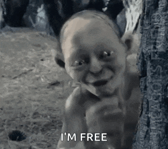 a black and white photo of a naked gollum standing next to a tree .
