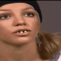 a close up of a woman 's face with missing teeth wearing a black hat .