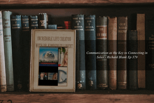 a book titled communication as the key to connecting in sales sits on a shelf