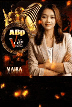 a woman stands with her arms crossed in front of a microphone with the abp logo in the background